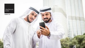 Two Local Arab Men viewing phone