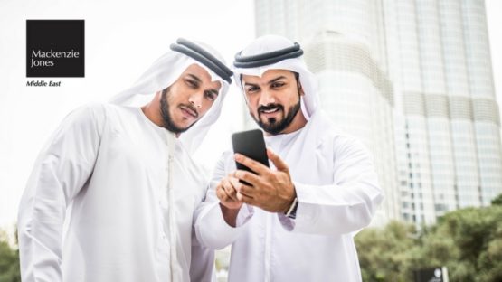 Two Local Arab Men viewing phone